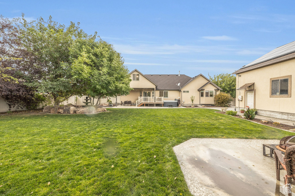 View of yard with a patio and a deck