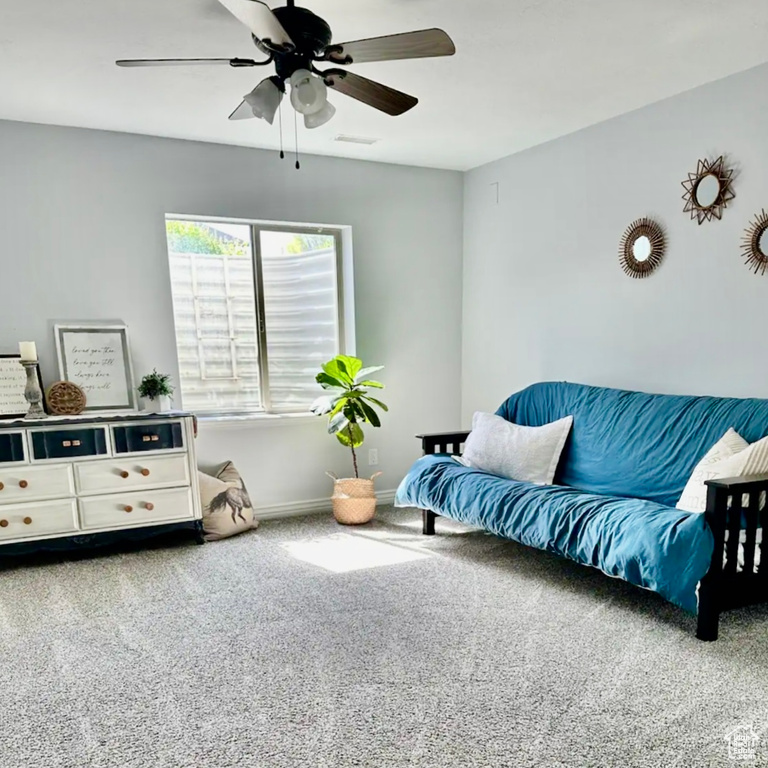 Interior space featuring carpet and ceiling fan