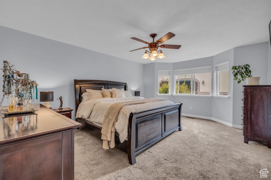 Carpeted bedroom with ceiling fan