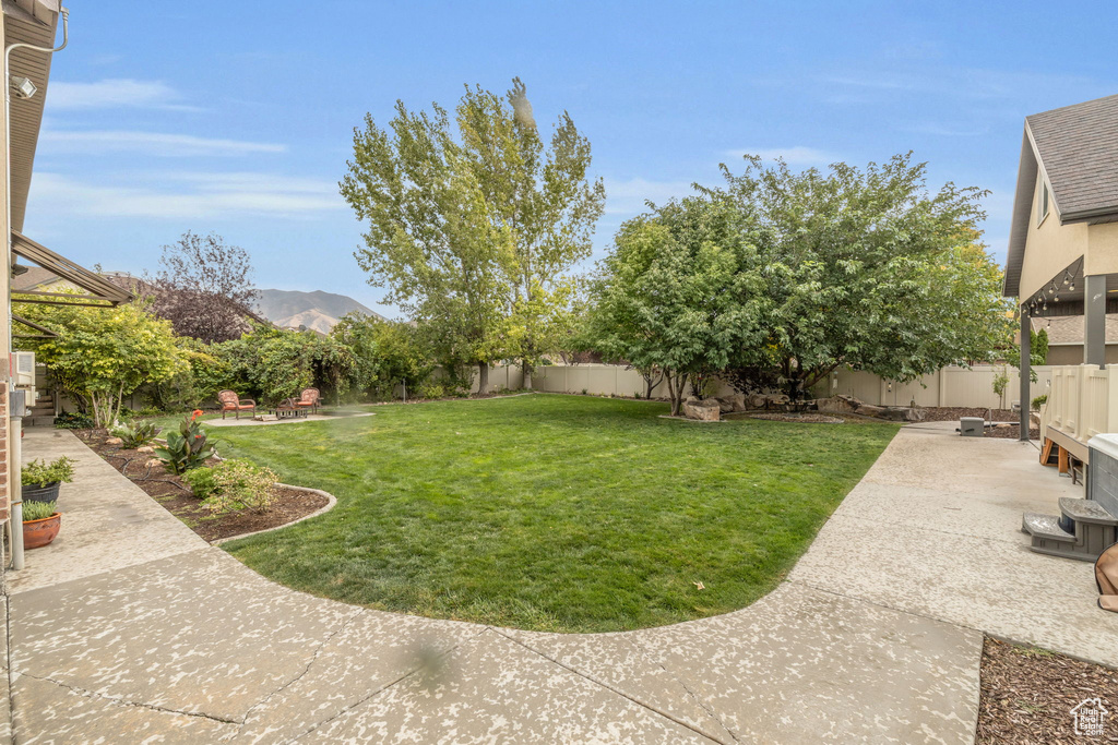 View of yard with a mountain view and a patio area