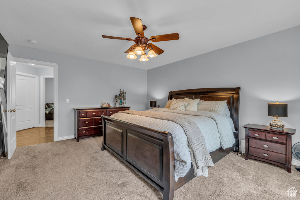 Carpeted bedroom featuring ceiling fan