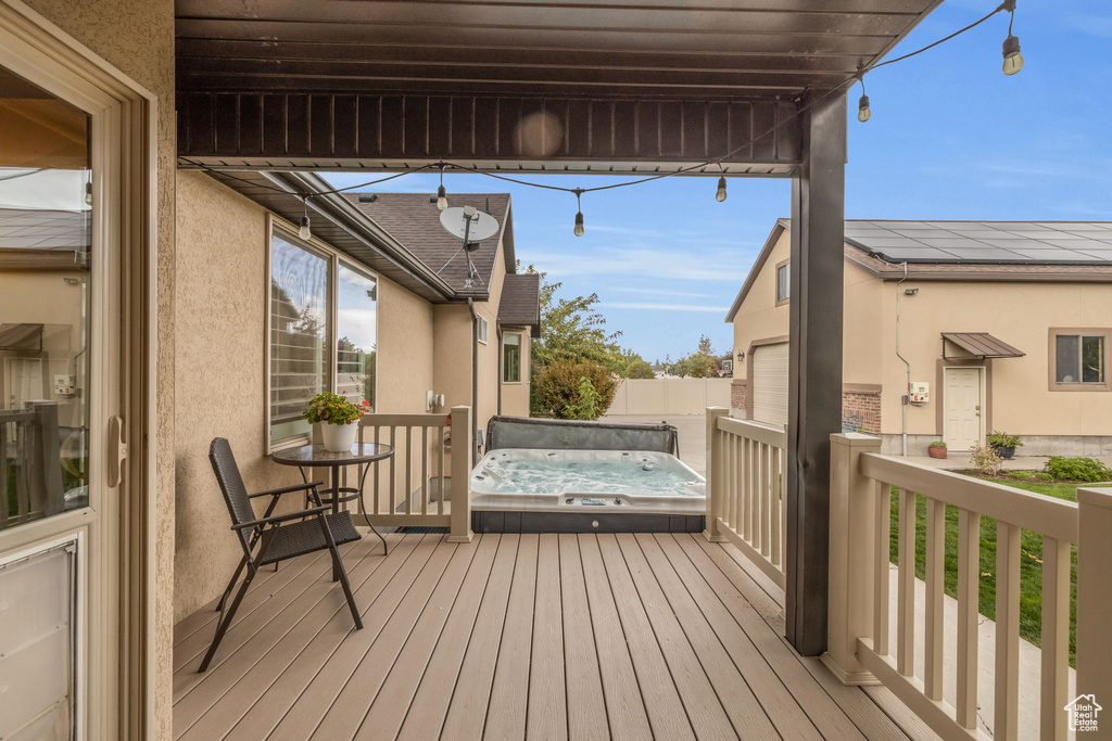 Deck featuring a covered hot tub