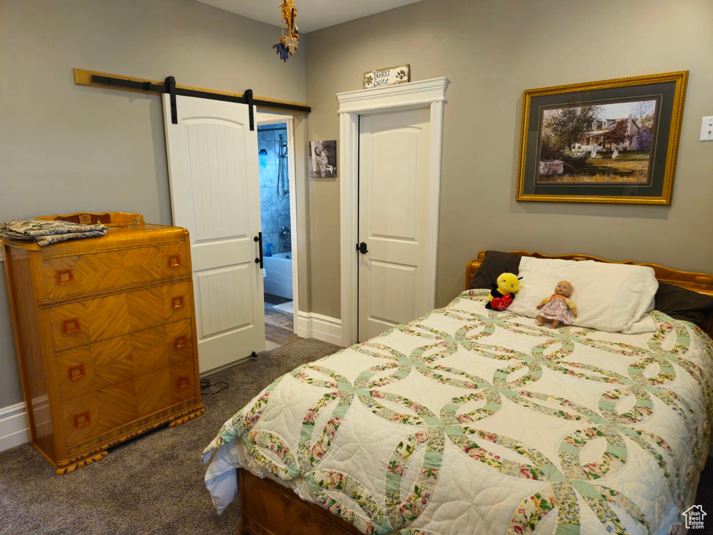 Carpeted bedroom with ensuite bath and a barn door