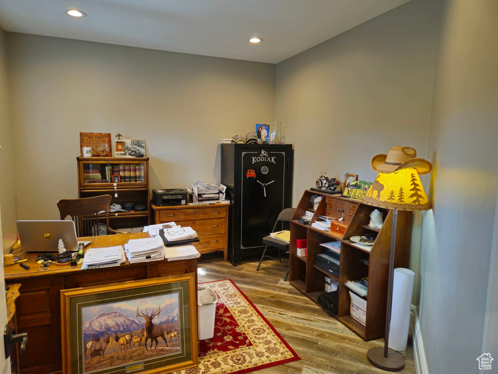 Home office with hardwood / wood-style flooring