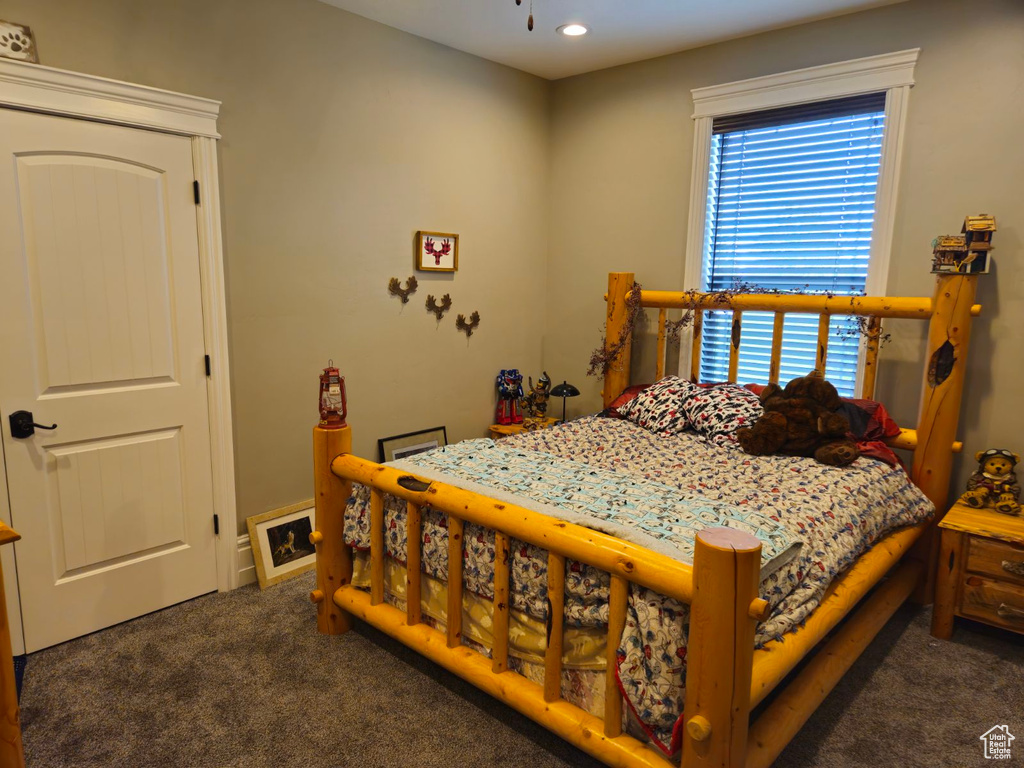 Bedroom featuring dark carpet