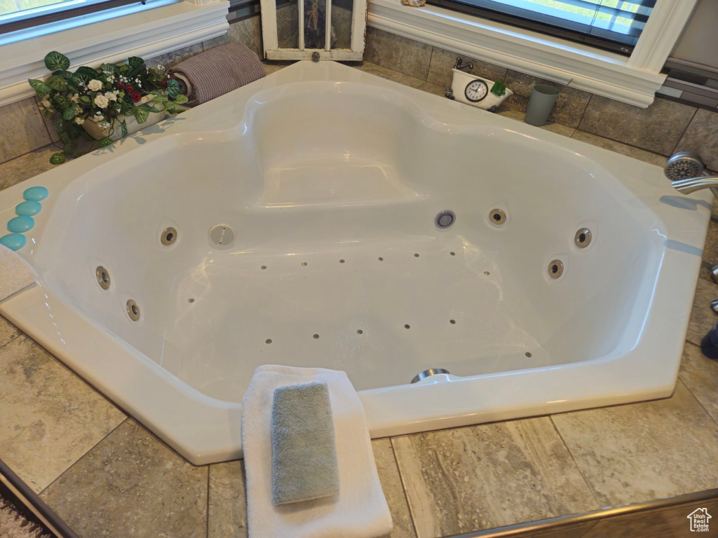 Bathroom with a skylight and tiled bath