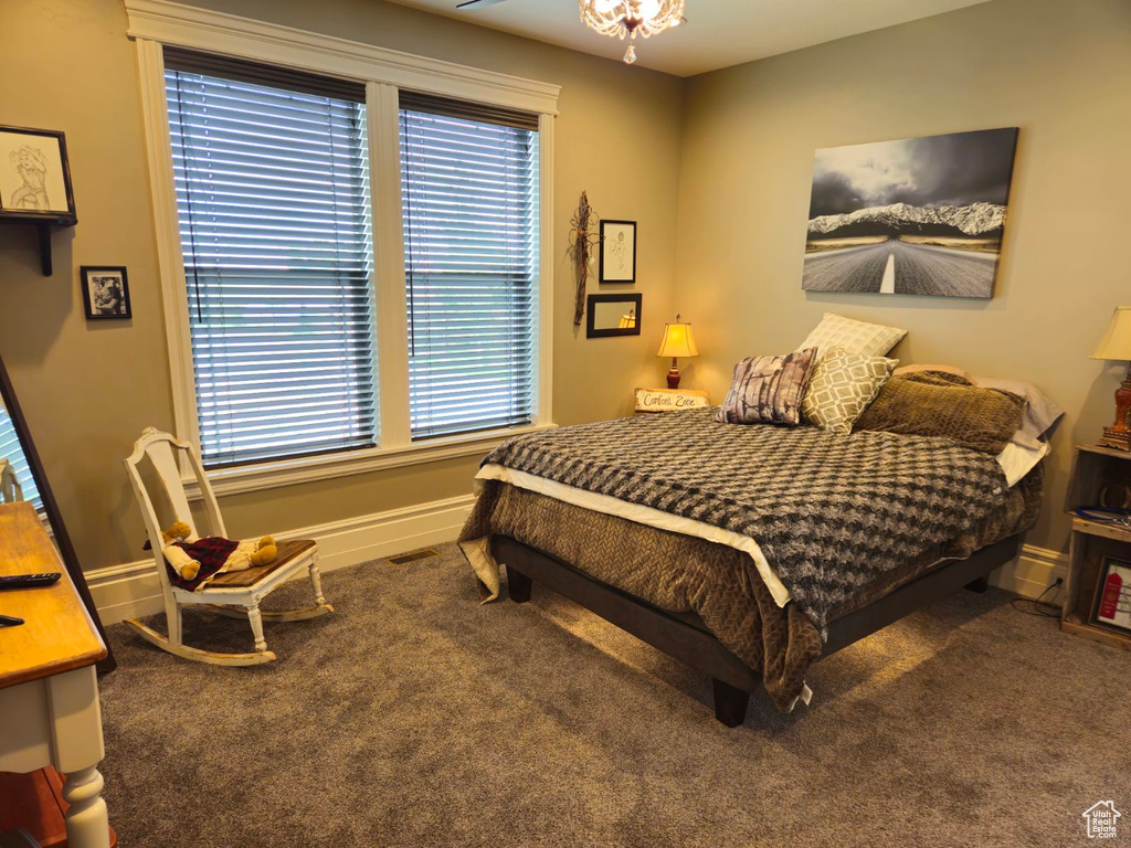 Carpeted bedroom with multiple windows