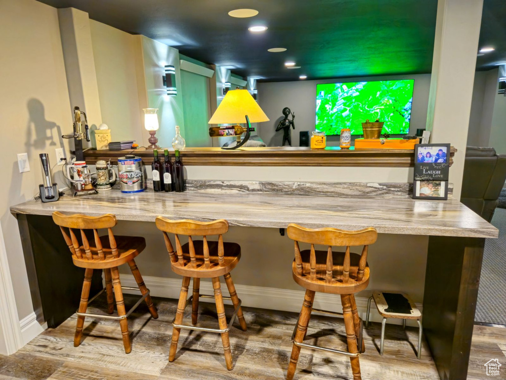 Bar featuring wood-type flooring