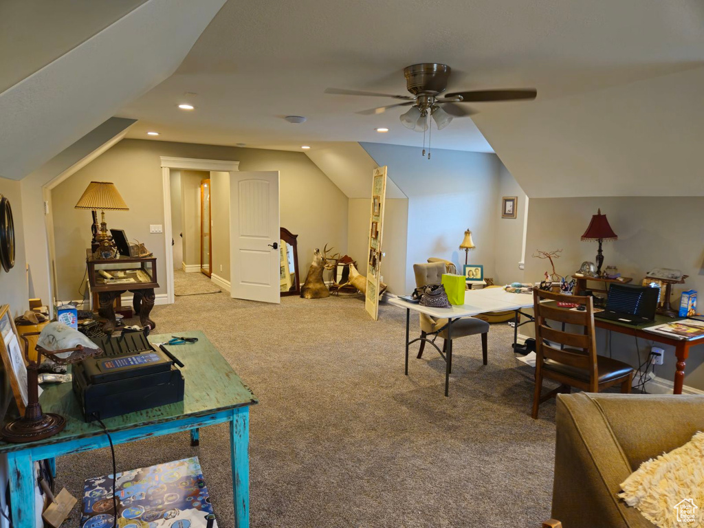 Interior space with carpet, vaulted ceiling, and ceiling fan