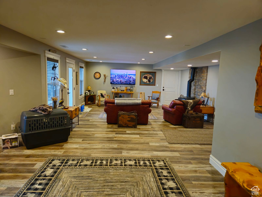 Living room featuring hardwood / wood-style flooring and a wood stove