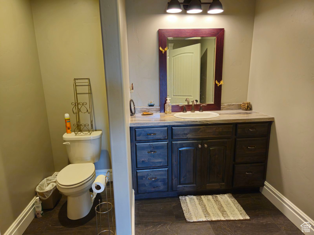 Bathroom with vanity, toilet, and hardwood / wood-style flooring