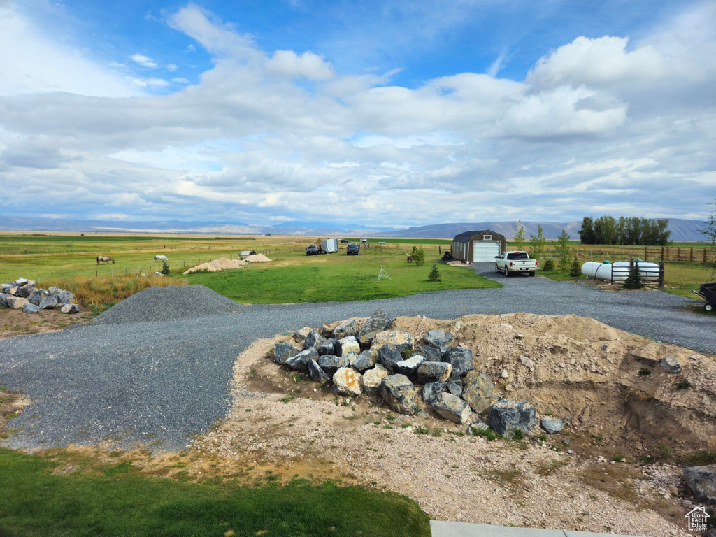 Exterior space featuring a mountain view, a rural view, and a garage