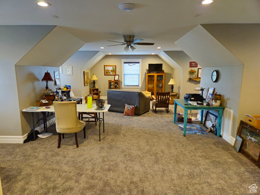 Interior space with ceiling fan and vaulted ceiling