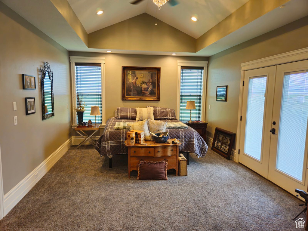 Carpeted bedroom featuring french doors, vaulted ceiling, ceiling fan, and access to outside