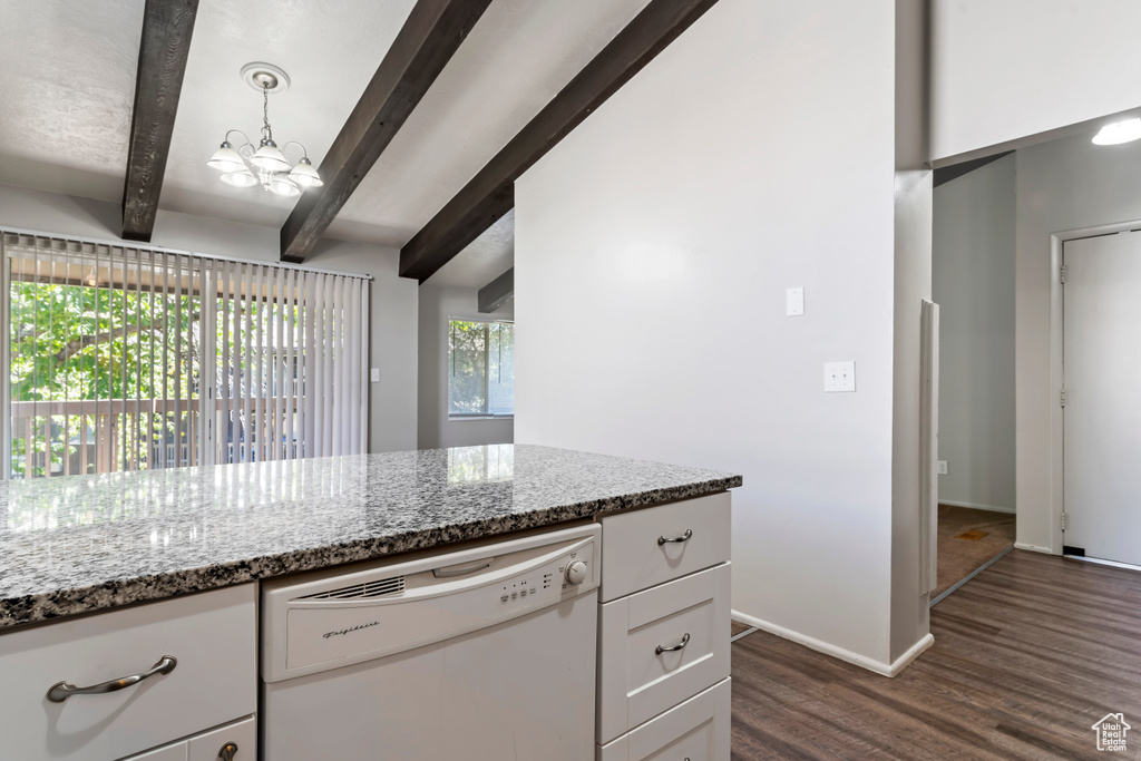 Kitchen with pendant lighting, dishwasher, beamed ceiling, white cabinets, and light stone countertops