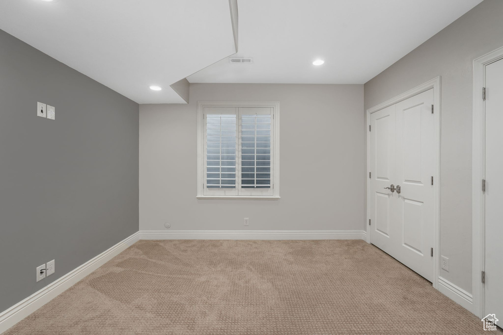 Empty room with light colored carpet