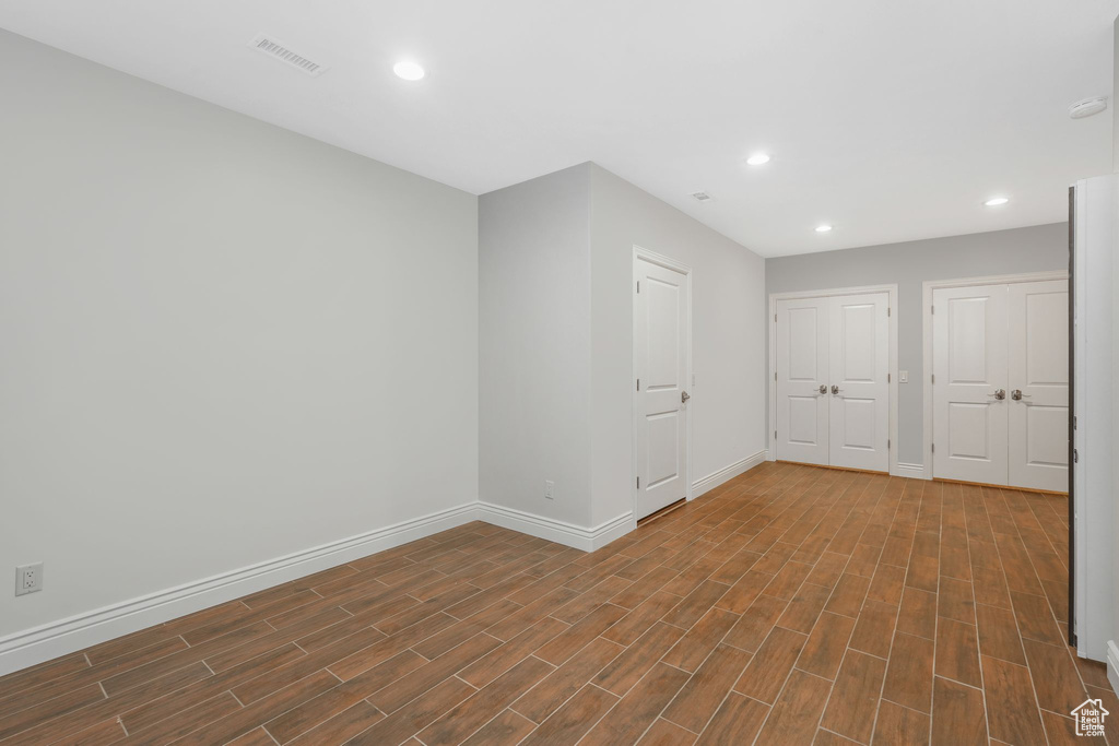 Unfurnished room with dark hardwood / wood-style flooring