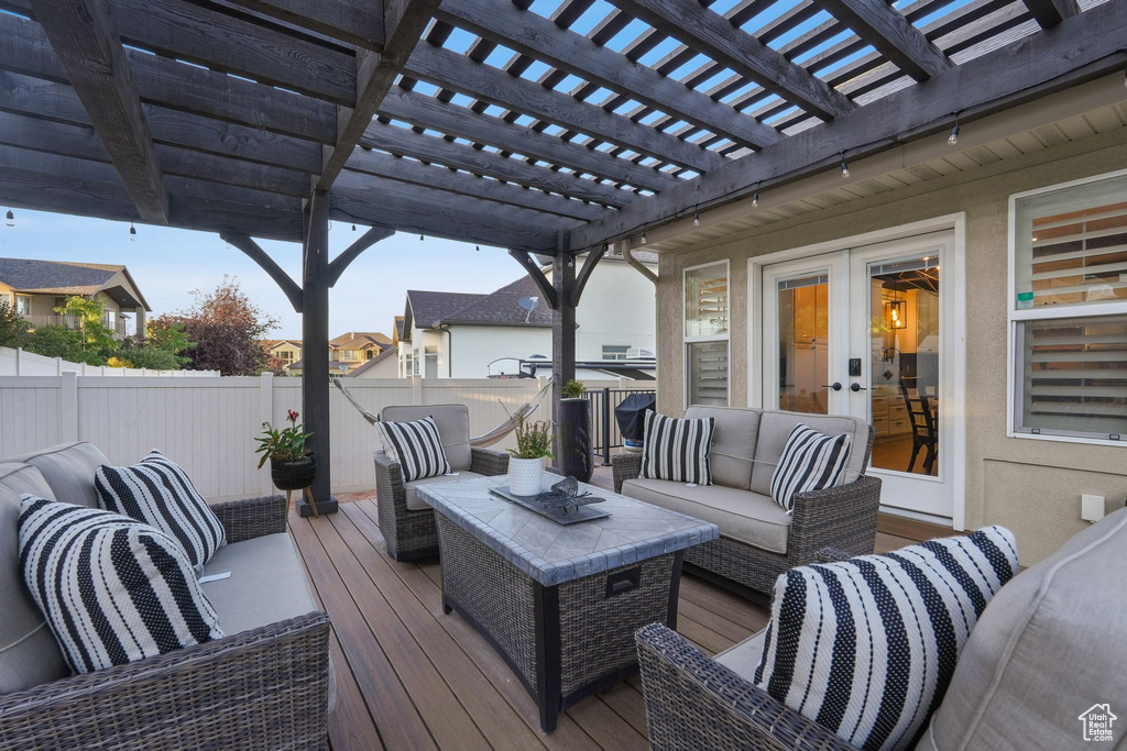 Deck with a pergola and outdoor lounge area