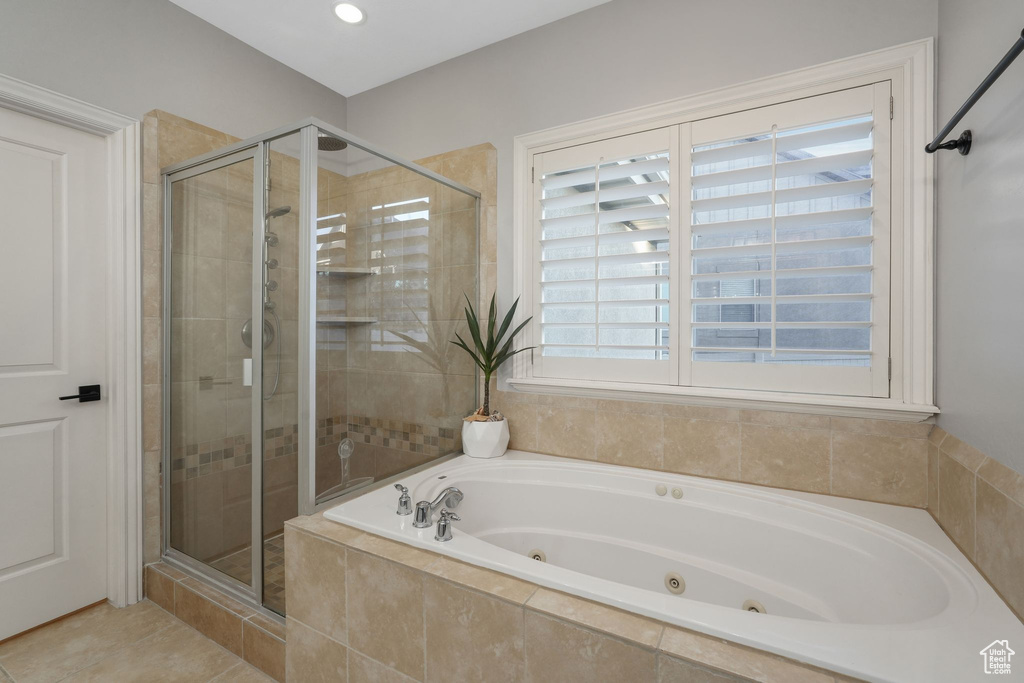 Bathroom with separate shower and tub and tile patterned floors