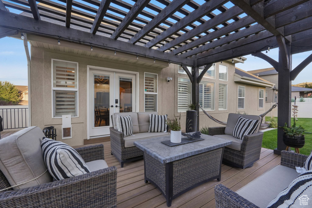 Deck featuring a pergola, outdoor lounge area, and french doors