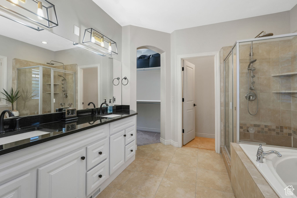 Bathroom featuring vanity, separate shower and tub, and tile patterned floors