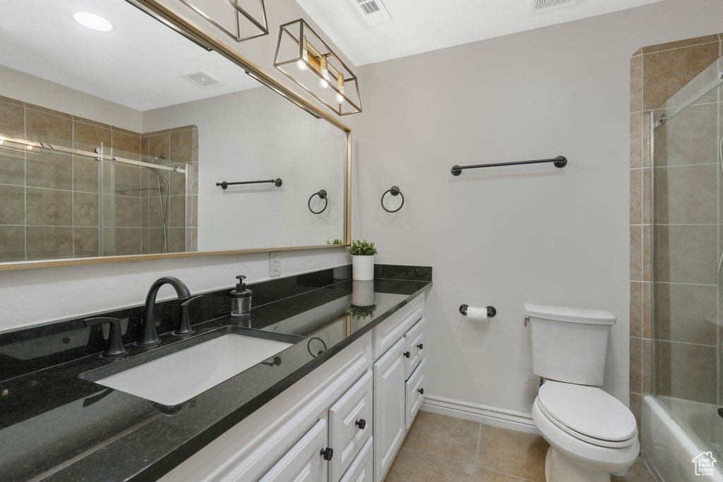 Bathroom featuring vanity, toilet, and tile patterned floors