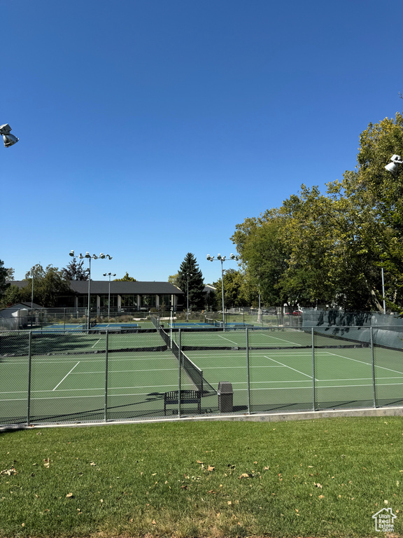 View of sport court featuring a yard