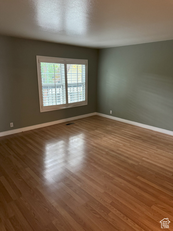 Empty room featuring hardwood / wood-style floors