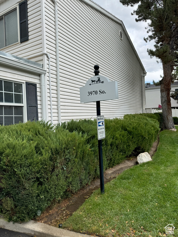 View of side of home featuring a lawn