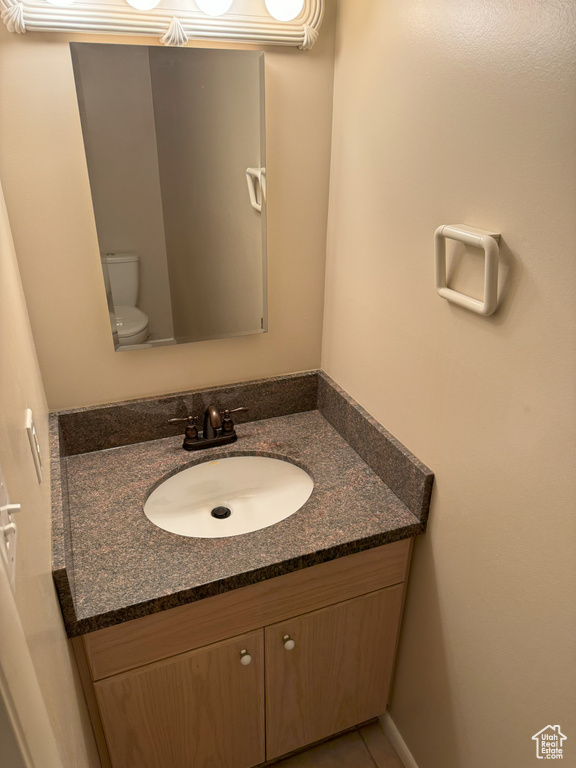 Bathroom featuring vanity and toilet