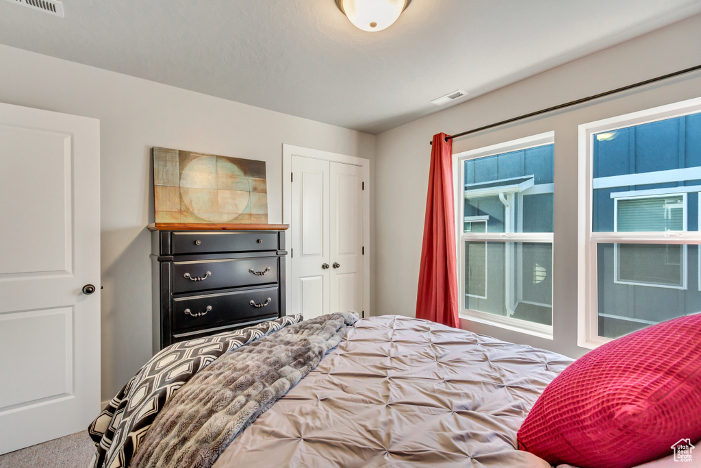 Bedroom with carpet flooring and a closet