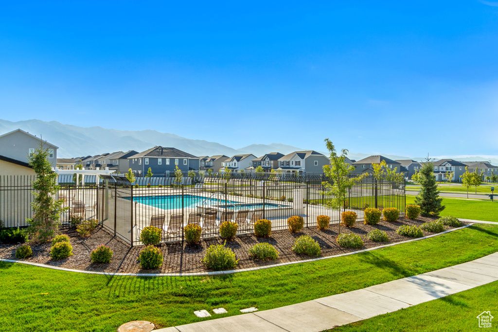 View of swimming pool featuring a yard and a mountain view