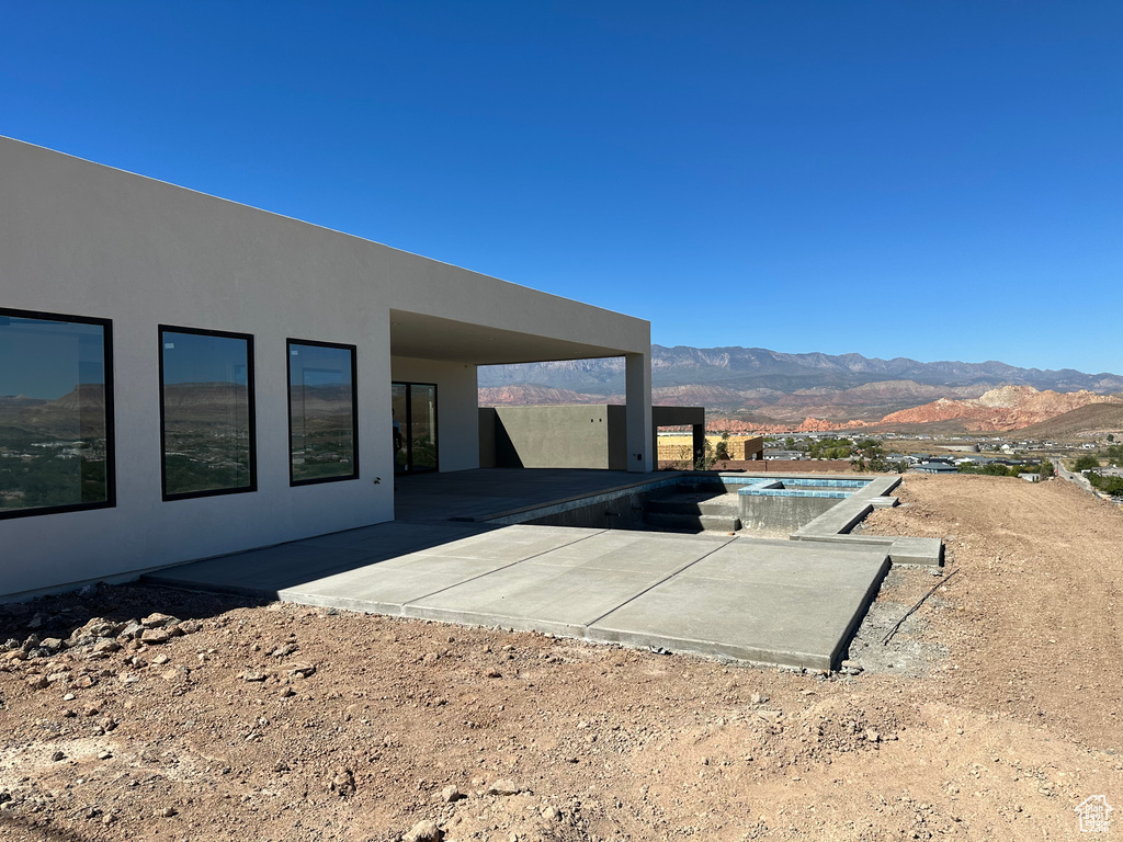 Exterior space with a mountain view and a patio area