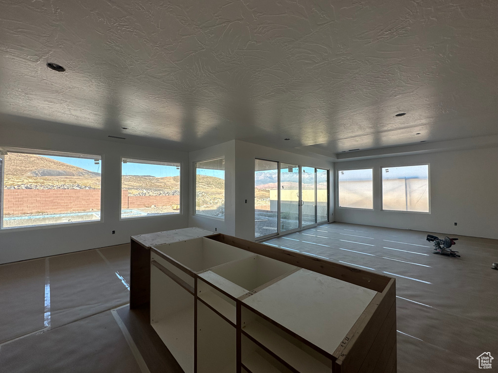 Kitchen featuring a mountain view, plenty of natural light, and a textured ceiling