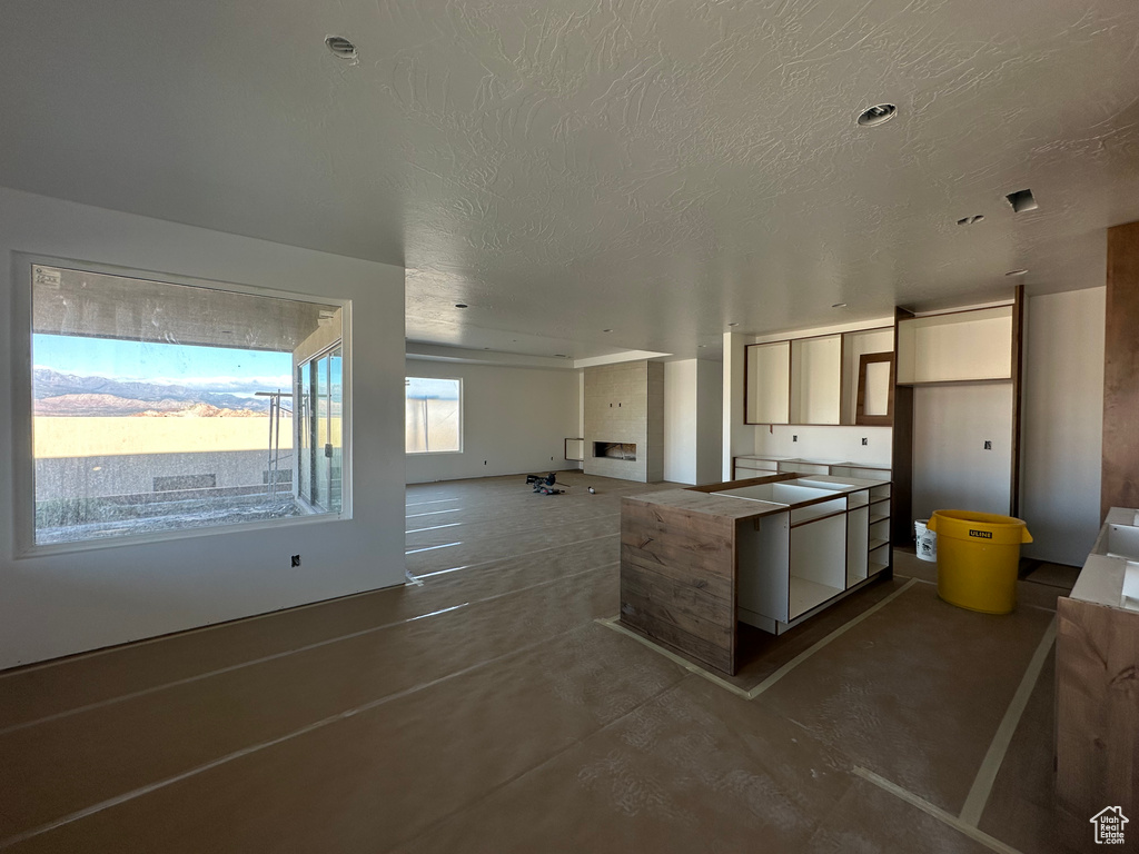 Kitchen featuring a textured ceiling and concrete floors