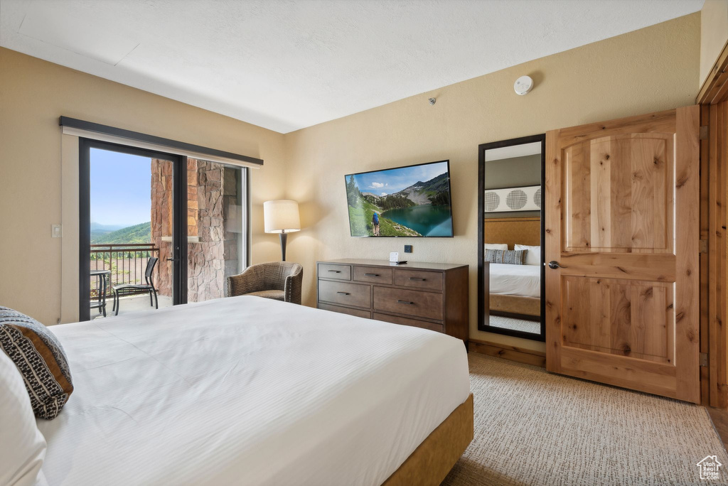 Bedroom featuring carpet floors, access to outside, and french doors