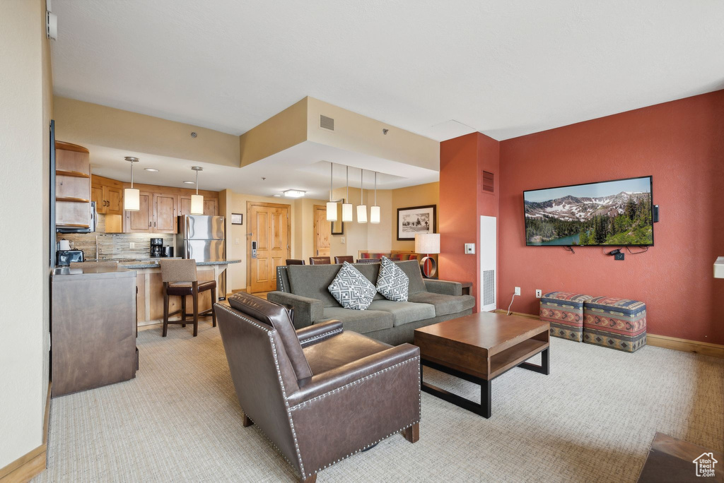 Carpeted living room featuring sink