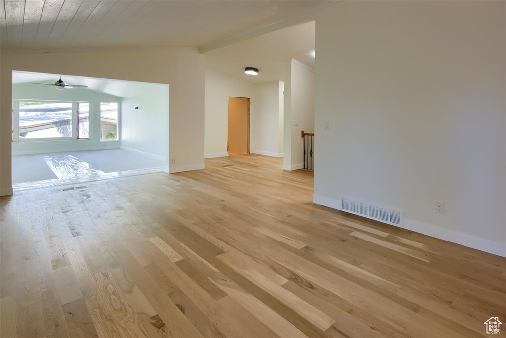 Unfurnished room with light wood-type flooring, vaulted ceiling with beams, ceiling fan, and wooden ceiling