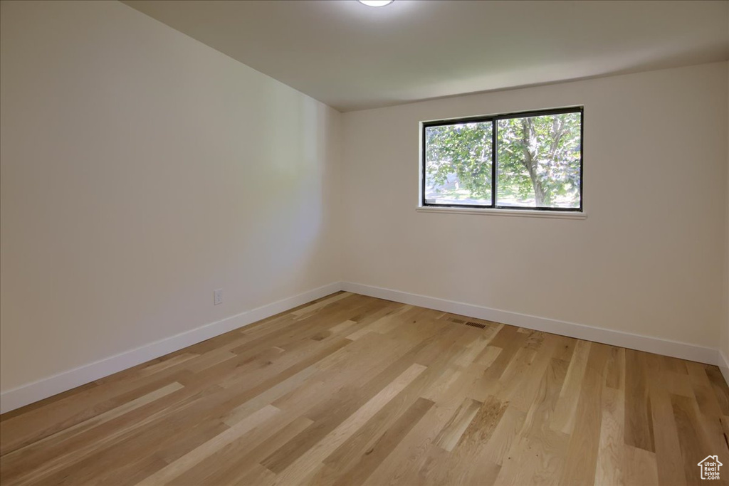 Spare room with light wood-type flooring