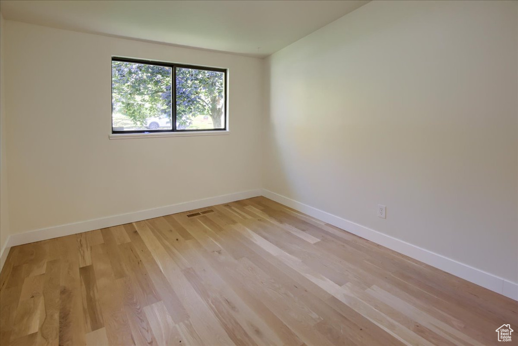 Unfurnished room featuring light wood-type flooring