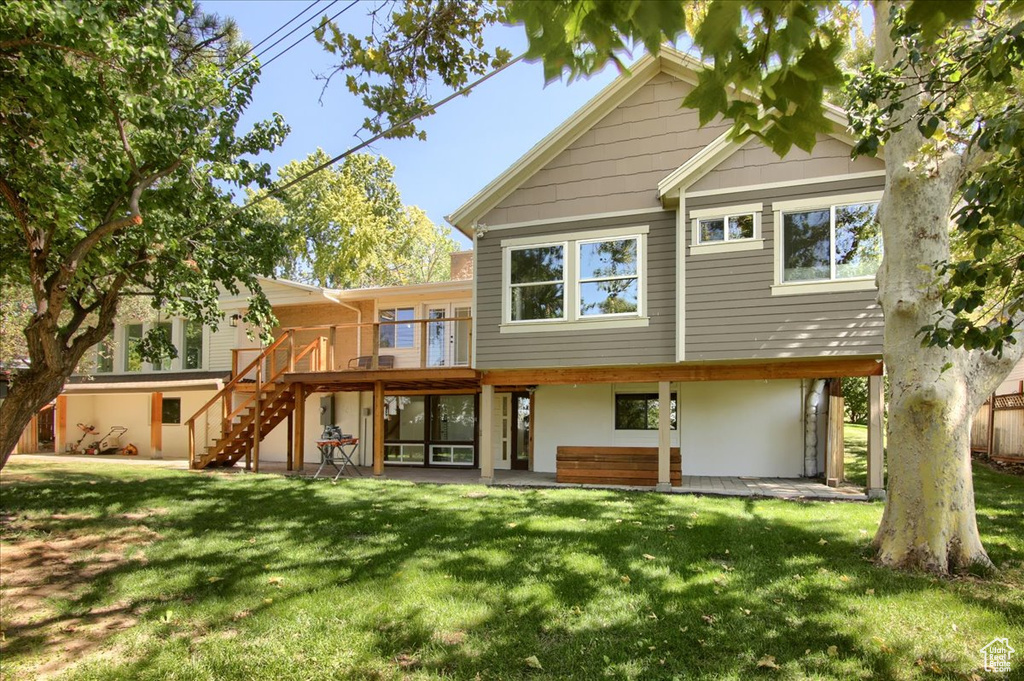 Rear view of property featuring a yard and a patio area