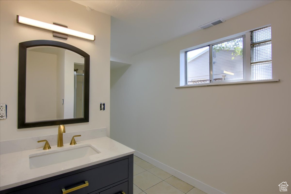 Bathroom with tile patterned flooring and vanity