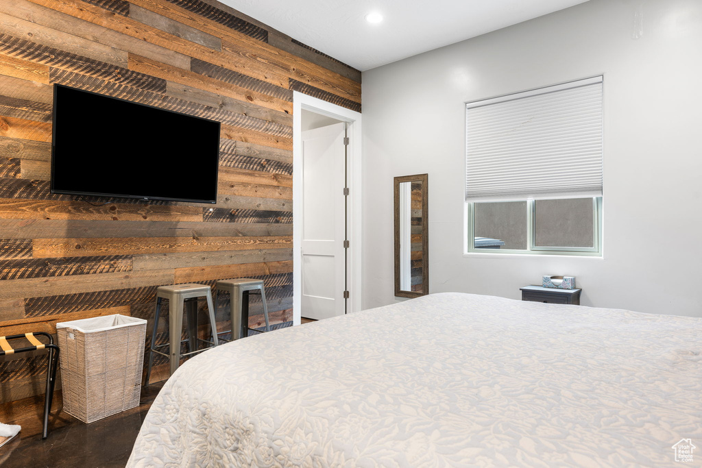 Bedroom featuring wood walls