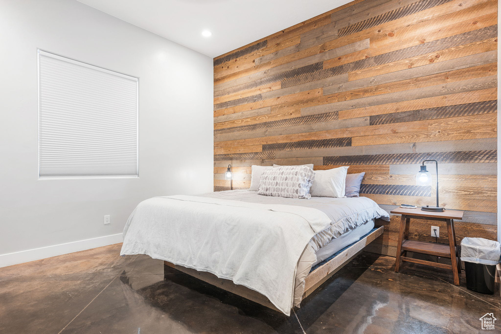 Bedroom with wood walls