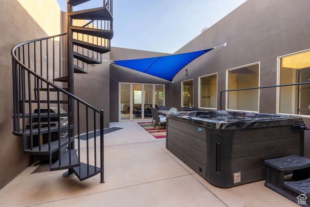 View of patio with a hot tub