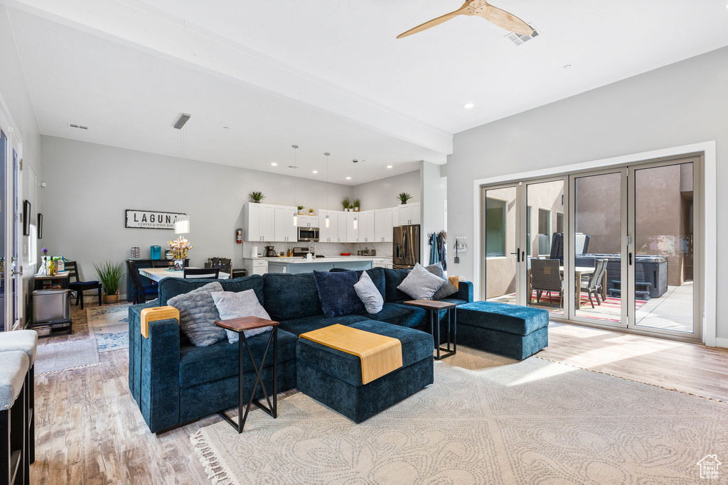 Living room featuring light hardwood / wood-style flooring and ceiling fan