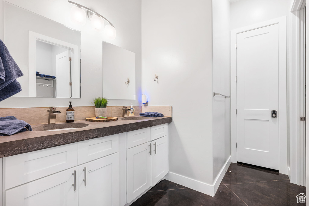 Bathroom featuring tile patterned floors and vanity