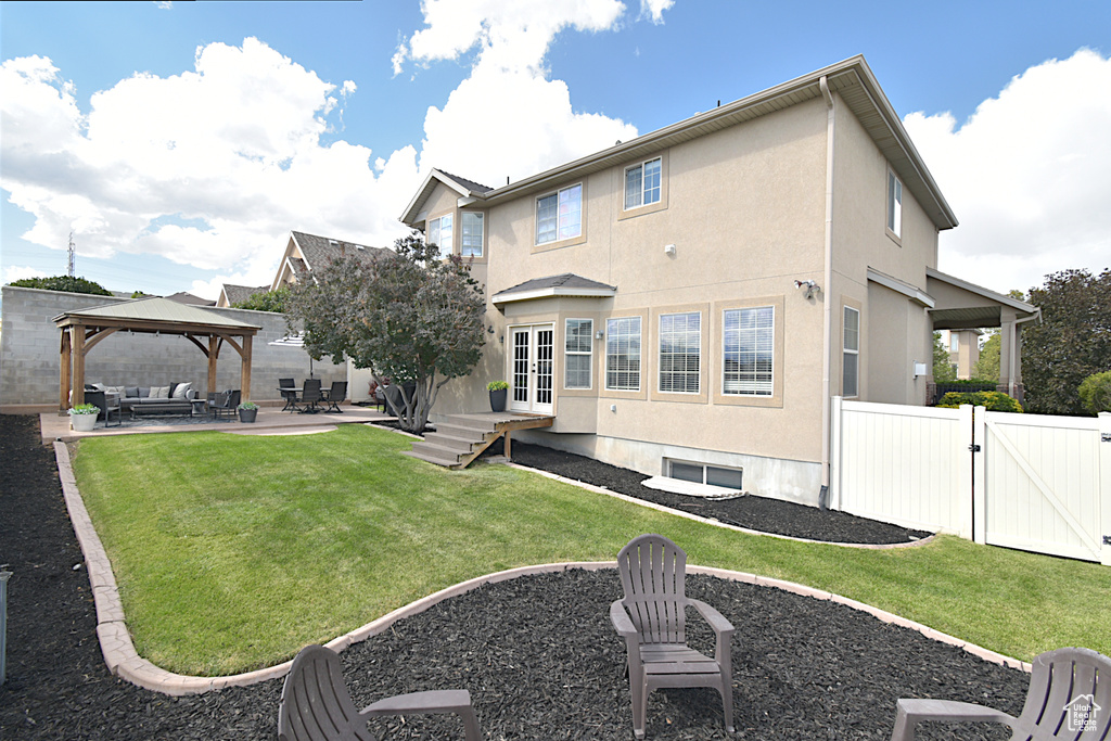 Rear view of house featuring an outdoor living space, a gazebo, a yard, and a patio area