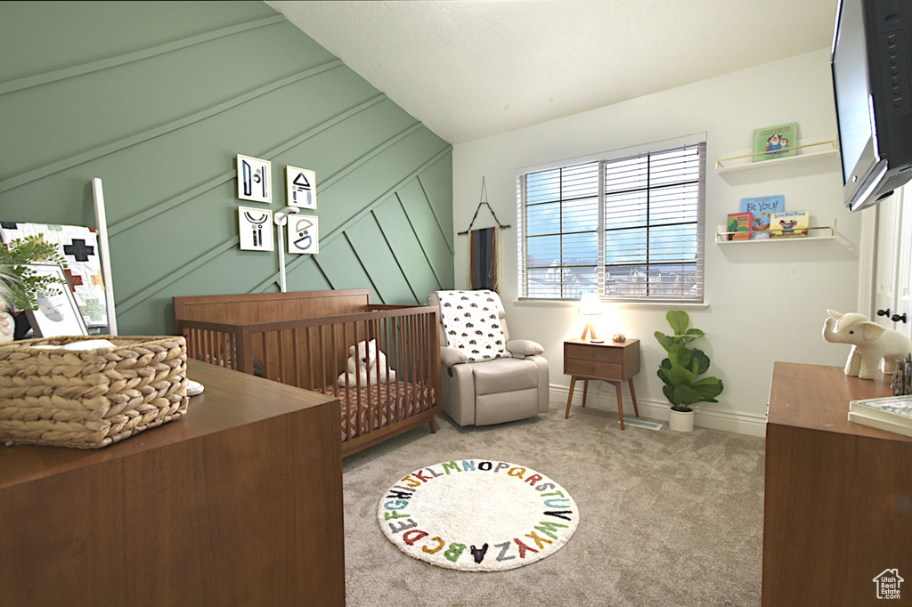 Carpeted bedroom with a nursery area