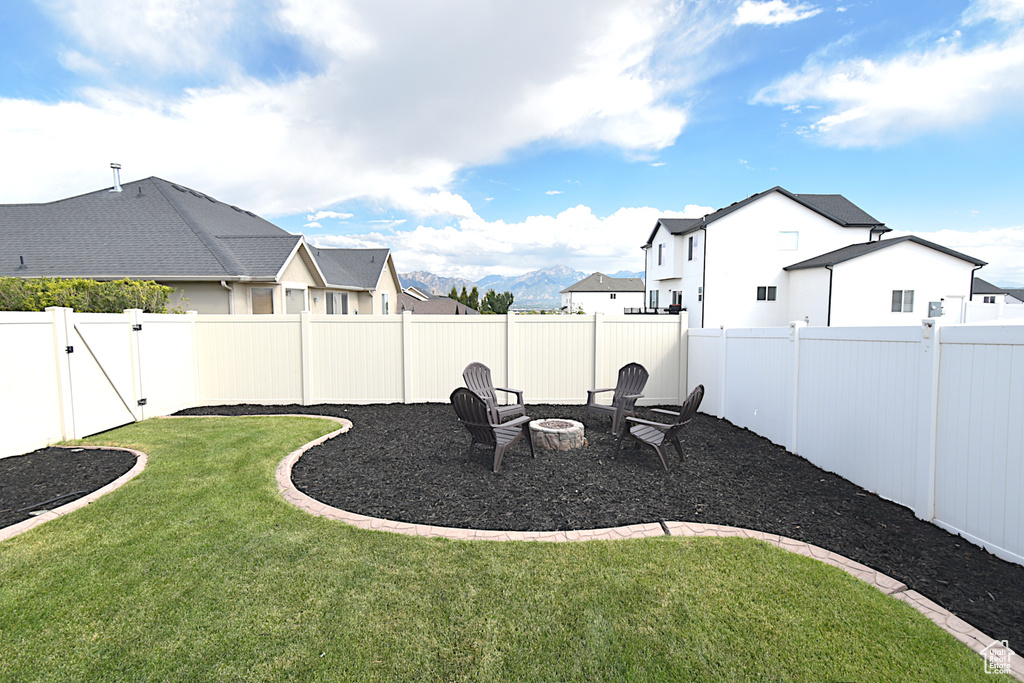 View of yard with a fire pit and a mountain view